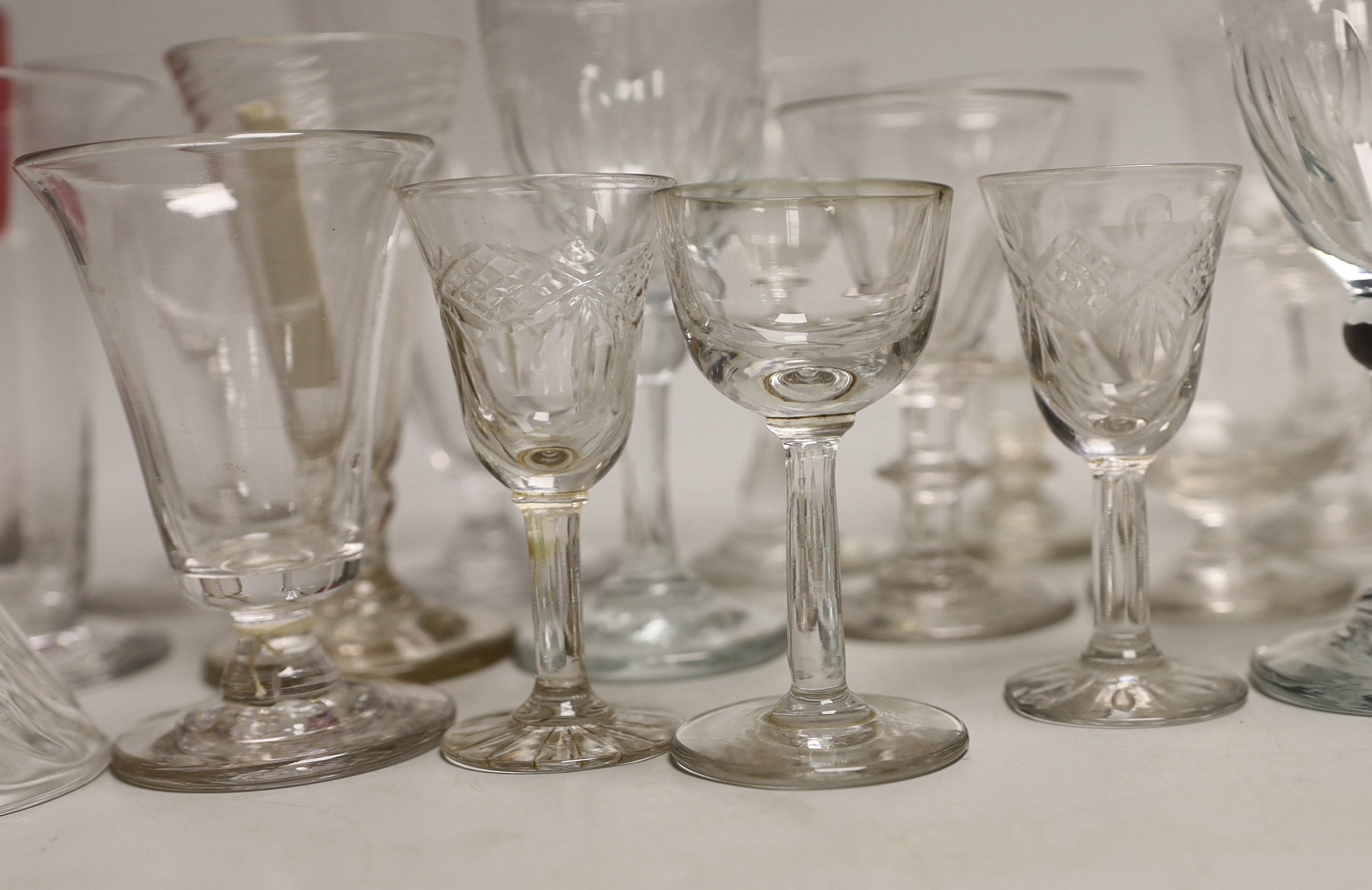 A quantity of antique and later glasses including a Georgian dwarf ale glass and Victorian cranberry example the largest 14cm high